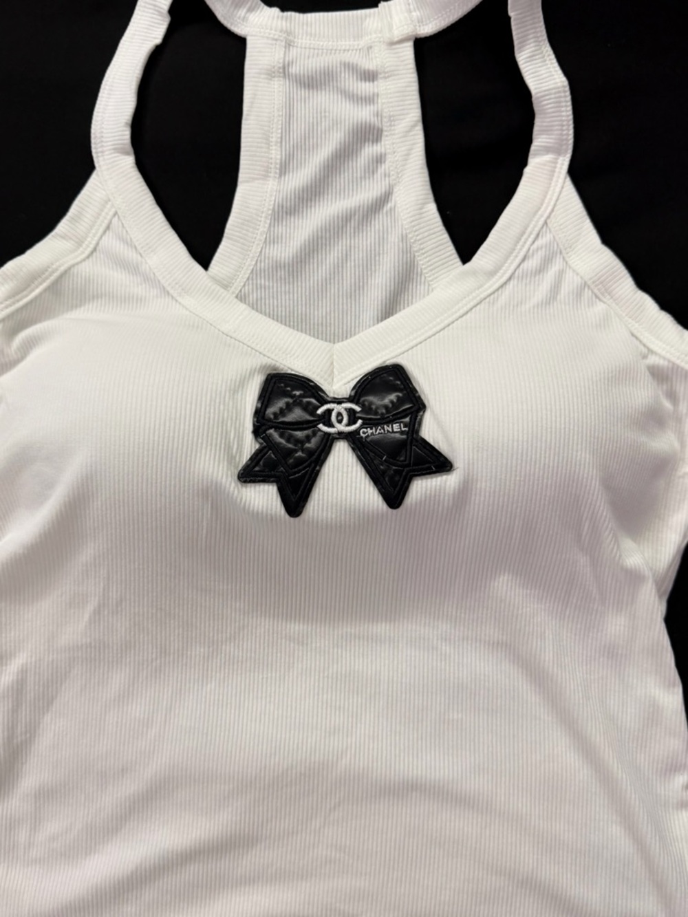 White and black all sizes.Ribbed Racerback Tank with Black Bow Patch.
